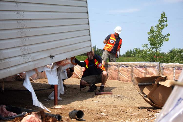 Brandon Sun
Environment Canada personnel take the measurements of a home a tornado ripped off its foundation in Sioux Valley Dakota Nation.