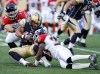 Jessica Burtnick / Winnipeg Free Press
Aaron Woods is brought down by Stampeders' Chris Randle, 33, and Matt Walter, 14 Friday night at Investors Group Field. The Blue Bombers lost 37-24.