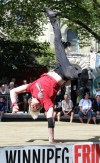 Mike Deal / Winnipeg Free Press
Mike Deal / Winnipeg Free Press
Devin Shen of the Strength Project crosses the stage on his hands in Old Market Square during the final day of the fringe festival Sunday afternoon.