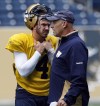 KEN GIGLIOTTI / WINNIPEG FREE PRESS
Buck Pierce, left, was all business today as offensive co-ordinator Gary Crowton passes by. Bomber head coach Tim Burke announced before practice this morning that Justin Goltz would be the club’s starter for the rest of the season, with Pierce transitioning into 