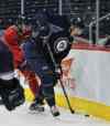 Mike Deal / Winnipeg Free Press
Prized prospect Adam Lowry (right) tries to control the puck while Zach Redmond works him into the corner.
