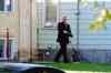 Mike Deal / Winnipeg Free Press
A Winnipeg police detective surveys the scene at an Essex Avenue home Sunday morning after a fatal shooting.