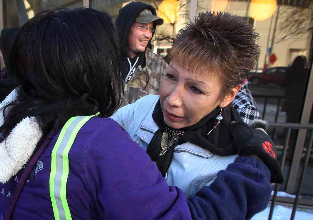 Mike Deal / Winnipeg Free Press
Sue Caribou (right), Tanya Nepinak's aunt, is hugged by a supporter Monday at a protest outside the Law Courts building in downtown Winnipeg.