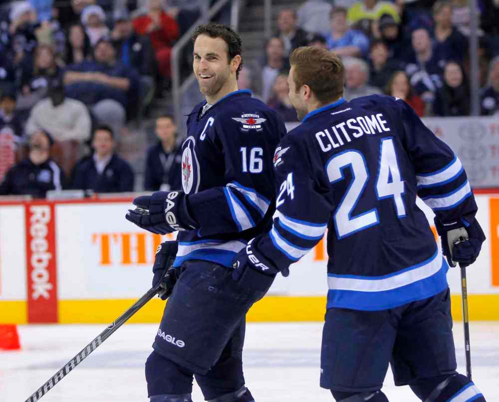 BORIS MINKEVICH / WINNIPEG FREE PRESS
Andrew Ladd (left) and Grant Clitsome share a laugh on the ice.