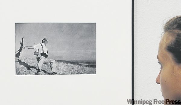 Manu Fernandez / the associated press
A visitor looks at Robert Capa’s Falling Militiaman — an enduring symbol of the Spanish Civil War — at a Barcelona exhibition.