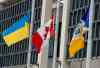 KEN GIGLIOTTI / WINNIPEG FREE PRESS
From left: the Ukrainian flag, Canadian flag and City of Winnipeg flag all stand at half-mast  in front of Winnipeg City Hall Wednesday.