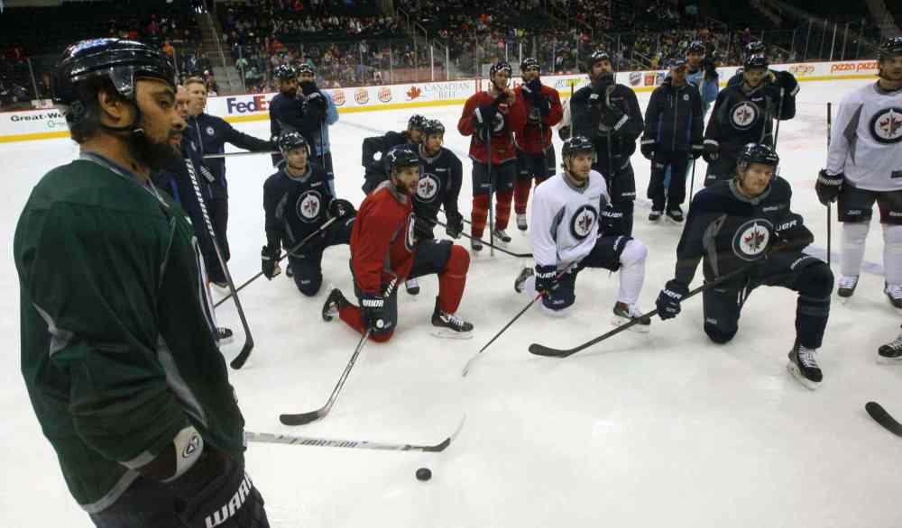 JOE BRYKSA / WINNIPEG FREE PRESS
Dustin Byfuglien (left) and teammates get some instruction at practice Monday at the MTS Centre. The Jets take on the Islanders tonight.
