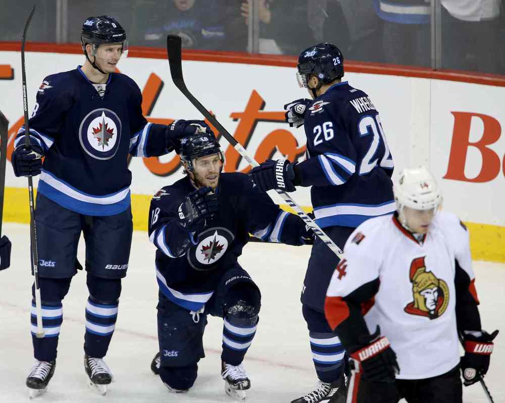 TREVOR HAGAN / WINNIPEG FREE PRES
Winnipeg Jets' Jacob Trouba (8), Bryan Little (18) and Blake Wheeler (26) celebrate as Ottawa Senators' Colin Greening (14) looks on after Little scored during first period NHL hockey action at MTS Centre in Winnipeg Saturday.
