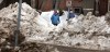 Phil Hossack / Winnipeg Free Press files
Dwarfed by piles of snow left over from winter, pedestrians make their way along Palmerston Avenue recently.