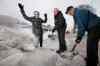 John Woods / Winnipeg Free Press
Susan McVarish cheers as Murray Greenley (centre) and Del Comerbach clean up the last remaining ice from the windrow left by snow plows in the back lane behind her house.