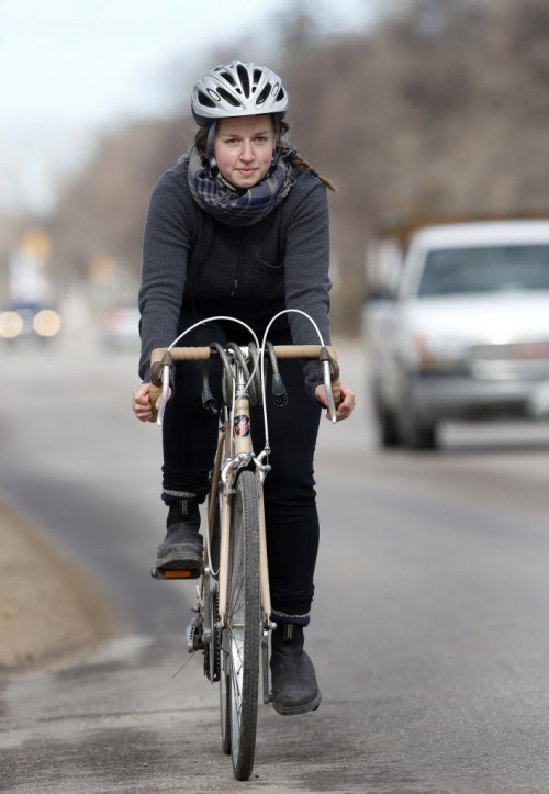 KEN GIGLIOTTI / WINNIPEG FREE PRESS
Rebecca Ward continues to ride her bike along Academy Road despite being hit by a car in the area a year ago.