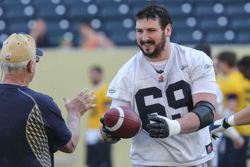 MIKE DEAL / WINNIPEG FREE PRESS
Glenn January tosses the ball back to quarterback coach Gene Dahlquist during the first official day of the Winnipeg Blue Bombers training camp last week. The team's CFLPA rep will be part of a conference call with the other reps tonight to discuss any progress made in new talks today.
