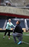 Phil Hossack / Winnipeg Free Press
Keri Robinson shows off her arm as quarterback Drew Willy offers some pointers Monday at the Blue and Gold Women's Club.