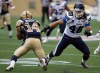 Phil Hossack / Winnipeg Free Press
Winnipeg Blue Bombers' Aaron Woods heads east as Toronto Argonaut Thomas Miles turns west on Thursday at Investors Group Field.