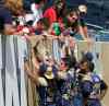 KEN GIGLIOTTI / WINNIPEG FREE PRESS 
Blue Bombers running back Paris Cotton (left) gives a young fan a high-five during a post-practice autograph session at Investors Group Field Wednesday afternoon.