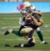 Phil Hossack / Winnipeg Free Press
Winnipeg Blue Bombers Julian Feoli-Gudino gets all wrapped up in Saskatchewan's Tyron Brackenridge's defence late in the game against the Saskatchewan Roughriders Thursday night.