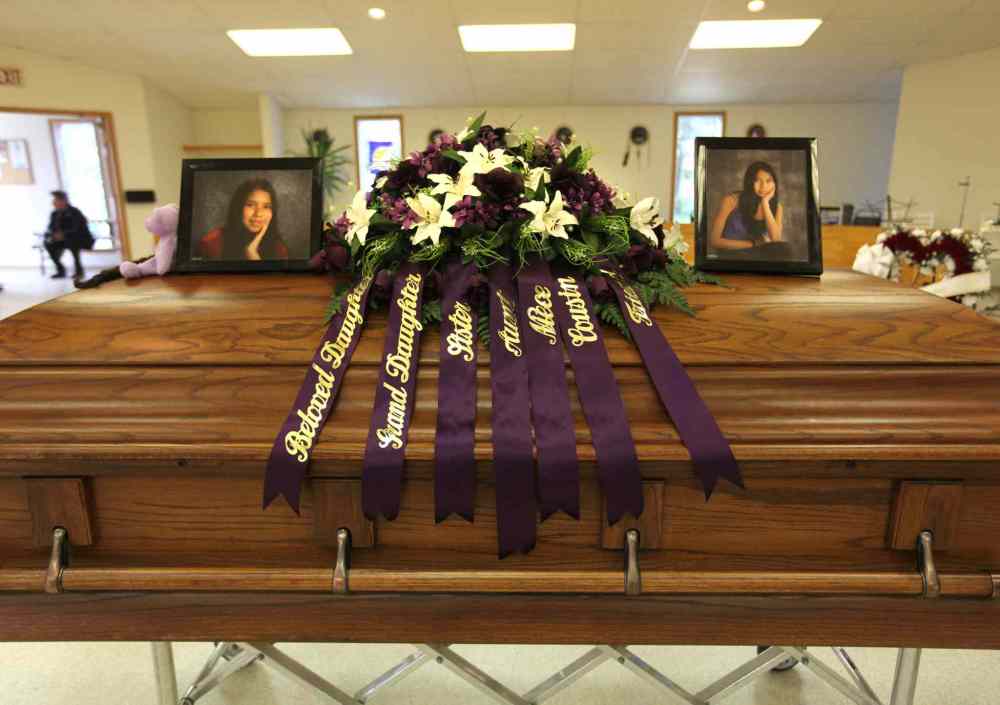 RUTH BONNEVILLE / WINNIPEG FREE PRESS Files
Tina Fontaine's photographs sit on top of her casket surrounded by flowers and items in the colour purple, her favourite colour. She had been caught in a net of drugs, alcohol and violence before she disappeared.