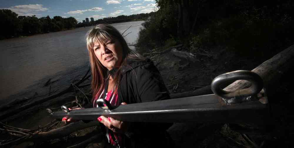 PHIL HOSSACK / WINNIPEG FREE PRESS
Bernadette Smith holds a bar that will be dragged along the bottom of the Red River in hopes of finding the remains of missing women and girls.