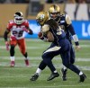 TREVOR HAGAN/WINNIPEG FREE PRESS
Winnipeg Blue Bombers' quarterback Brian Brohm (12) hands the ball to Paris Cotton (34) while playing against the Calgary Stampeders' during first half CFL action Saturday.