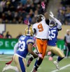 TREVOR HAGAN / WINNIPEG FREE PRESS
B.C. Lions' Ernest Jackson (9) catches a pass between Winnipeg Blue Bombers' Desia Dunn (23) and Bruce Johnson (25) during first half CFL football in Winnipeg Saturday.