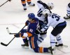 TREVOR HAGAN / WINNIPEG FREE PRESS
Winnipeg Jets' Bryan Little (18) and Tobias Enstrom (39) tangle with New York Islanders' John Tavares (91) during first period NHL hockey action at Nassau Coliseum, Uniondale, N.Y. Tuesday.