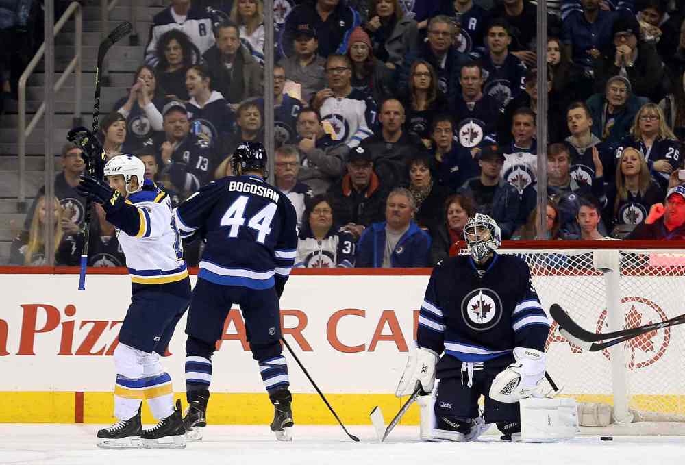 TREVOR HAGAN / WINNIPEG FREE PRESS
Jaden Schwartz of the St. Louis Blues celebrates after scoring a second-period goal against Jets goalie Ondrej Pavelec Sunday. Defenceman Zach Bogosian and the Winnipeg fans are less than enthralled.