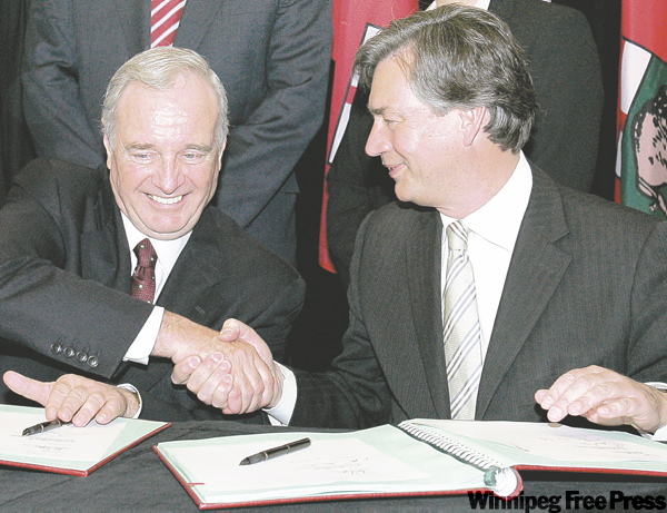 MARIANNE HELM / THE CANADIAN PRESS ARCHIVES
Prime Minister Paul Martin shakes hands with Doer after signing an agreement on early learning and child care in April 2005.