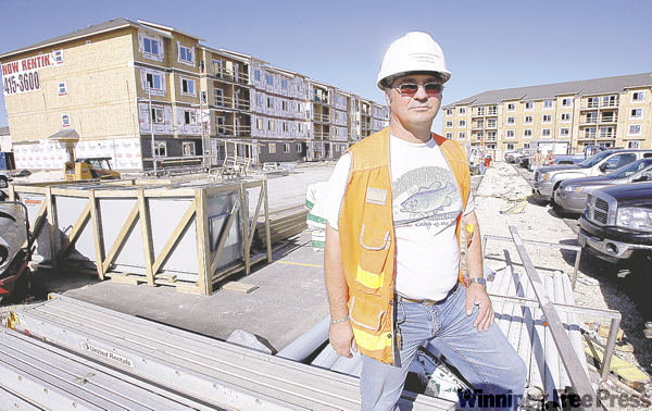BORIS.MINKEVICH@FREEPRESS.MB.CA
Dragomir Domuzin stands in front of some of the apartments being built as part of the Concordia Estates development.