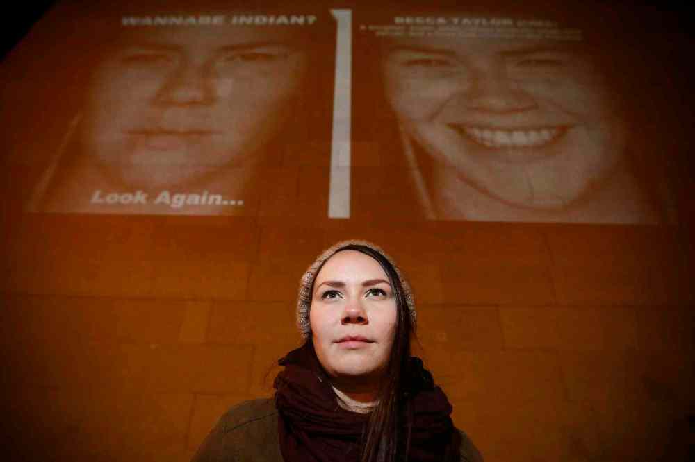JOHN WOODS / WINNIPEG FREE PRESS
Becca Taylor, a subject in the photography exhibit by KC Adams, stands in front of her image projected on the Winnipeg Art Gallery.