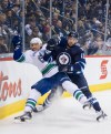 DAVID LIPNOWSKI / WINNIPEG FREE PRESS 
Winnipeg Jets' Drew Stafford (12) collides with Vancouver Canucks Christopher Tanev (8).