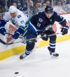 DAVID LIPNOWSKI / WINNIPEG FREE PRESS 
Winnipeg Jets' Tyler Myers (57) fights Vancouver Canucks' Shawn Mathias (27) for the puck.