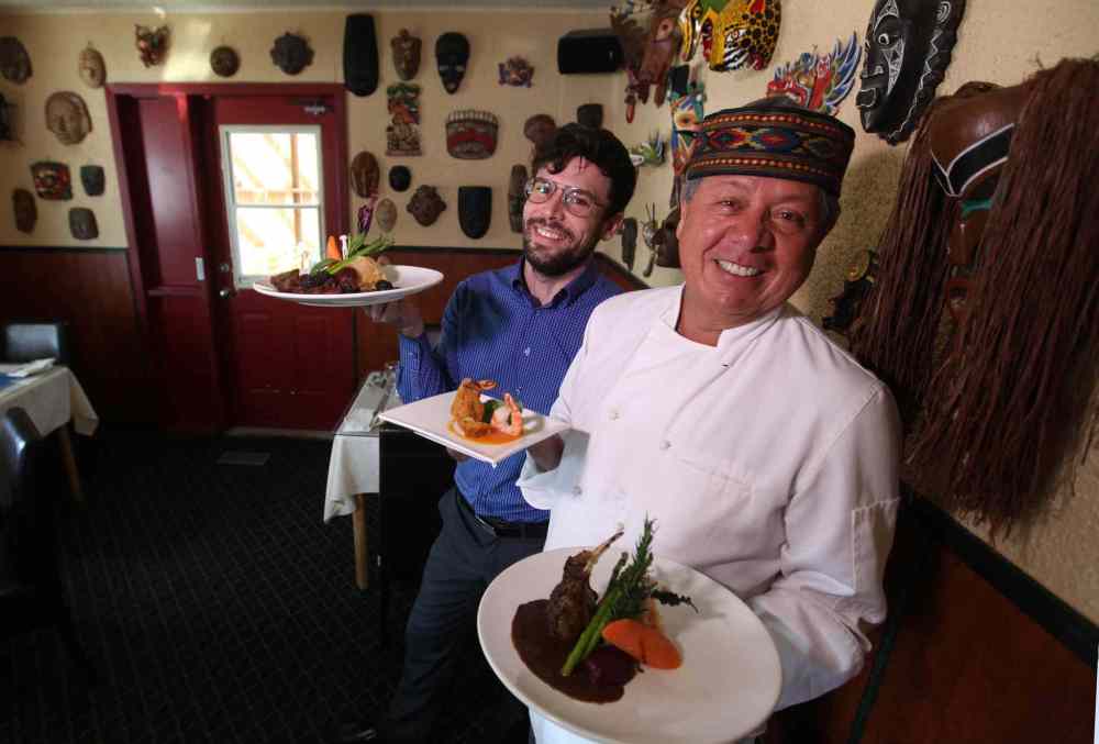 Ruth Bonneville / Winnipeg Free Press
Owner and head chef, Dario Pineda Gutierrez (front holding rack of lamb and shrimp app) with assistant Craig Becker (beef tenderloin).
