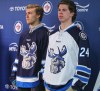 Mike Deal / Winnipeg Free Press
Manitoba Moose players Scott Kosmachuk (right) and JC Lipon model the new jersey for the Winnipeg Jets affiliate AHL team which is moving back to Winnipeg next season.