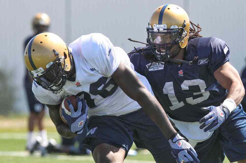 Mike Deal / Winnipeg Free Press
Mike Willie (76) is chased down by Don Unamba (13) during the first day of the Winnipeg Blue Bombers training camp Sunday.