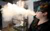 BORIS MINKEVICH / WINNIPEG FREE PRESS
‘Vape’ specialist Cierra Madison samples her product at the Cold Turkey Vape Shop Monday.