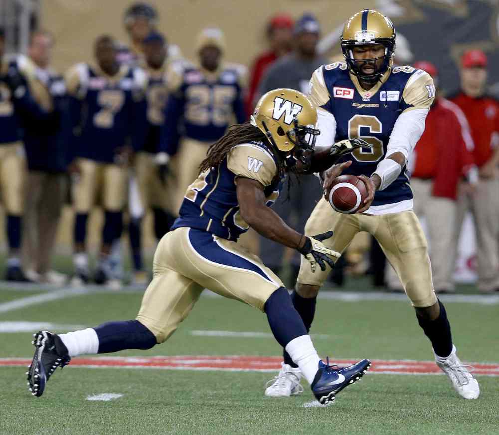 Trevor Hagan / Winnipeg Free Press
Winnipeg Blue Bombers' quarterback Josh Portis (6) hands the ball to Paris Cotton (34) as they play against the Hamilton Tiger-Cats' during preseason CFL action, Friday, June 19, 2015.