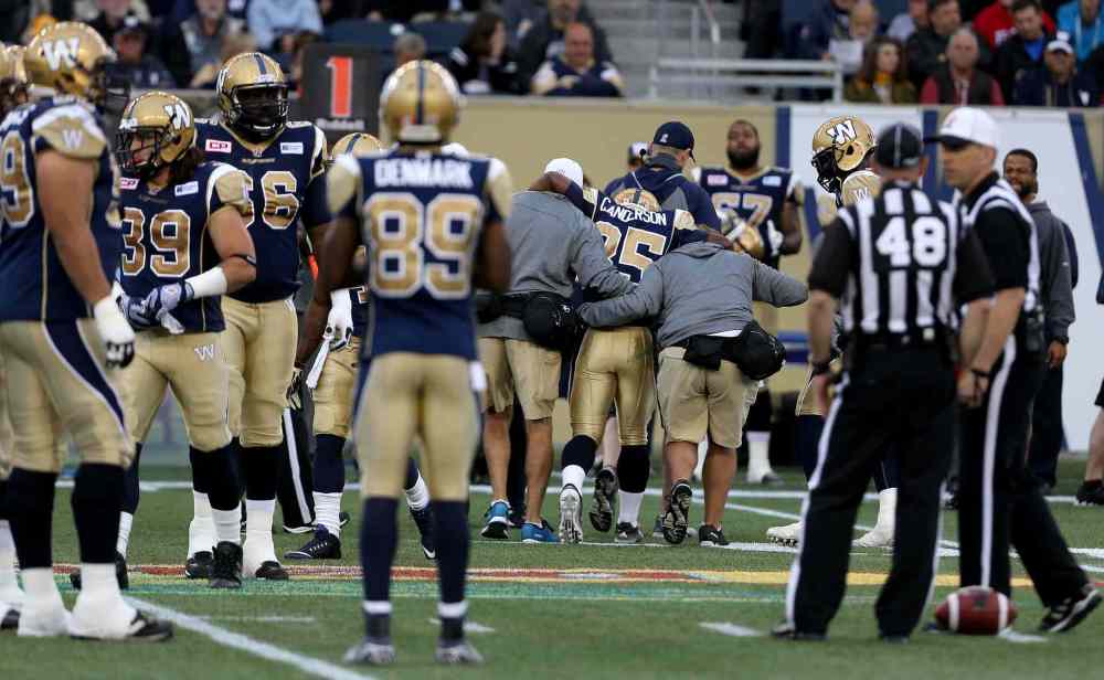 TREVOR HAGAN/WINNIPEG FREE PRESS
Winnipeg Blue Bombers' Carlos Anderson (35) is helped off the field after inuring his knee against the Hamilton Tiger-Cats' during preseason action. Anderson was cut Saturday evening as the Bombers were forced to trim down to the final 46-man roster.