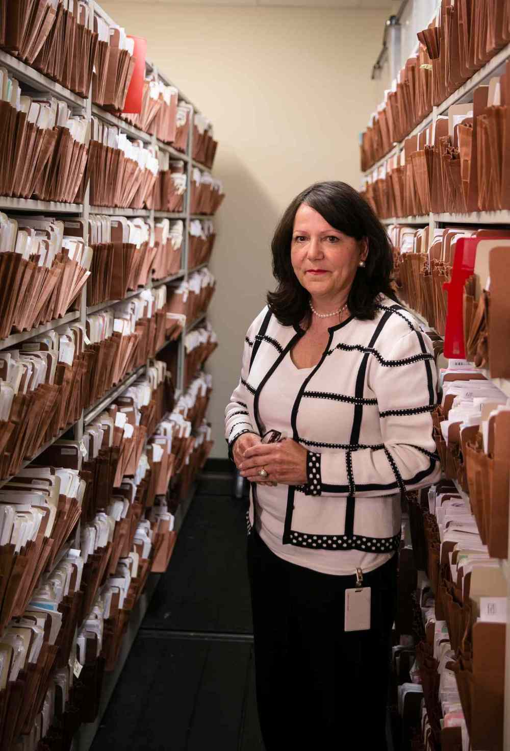 MELISSA TAIT / WINNIPEG FREE PRESS
Janice Knight, manager of adoption and post-adoption programs, among thousands of adoption records at the Family Services Department of Manitoba.