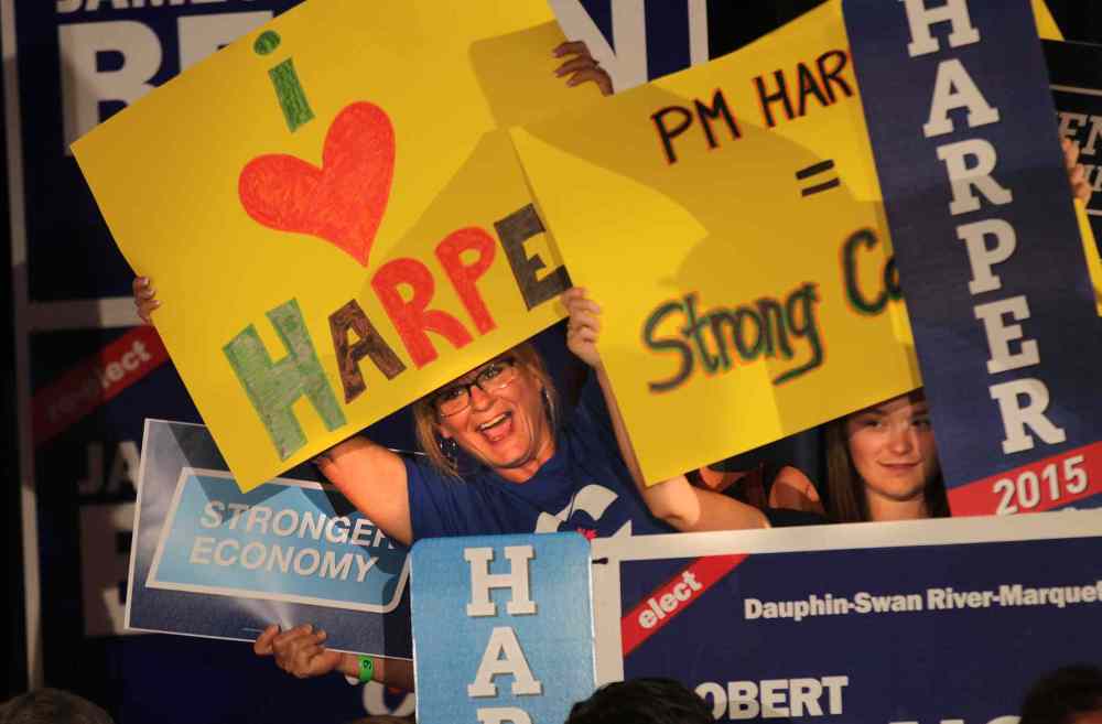 Packed and stacked, party faithfull peer out from beneath their placcards waiting for Prime Minister Stephen Harper at a party rally held in Winnipeg Thursday afternoon. (Phil Hossack / Winnipeg Free Press)