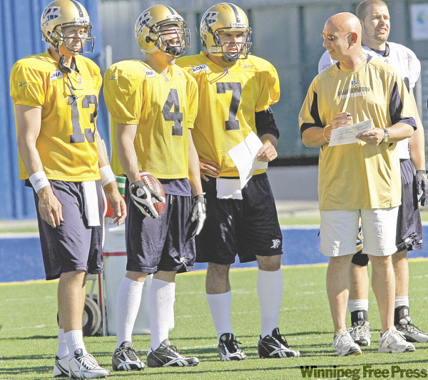 JOE.BRYKSA@FREEPRESS.MB.CA
New Bombers quarterbacks (from left) Casey Bramlet, Adam DiMichele and Ricky Santos get the once-over from head coach Mike Kelly at Canad Inns Stadium Thursday as running back Daryl Stephenson checks out the action on the field.