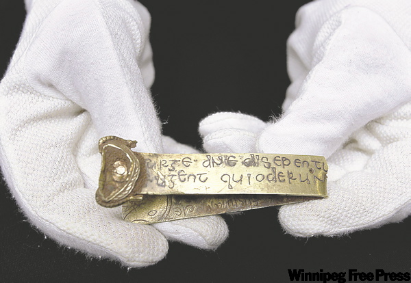 KIRSTY WIGGLESWORTH / THE ASSOCIATED PRESS
A strip of gold bearing a biblical inscription in Latin is part of a recently discovered treasure.