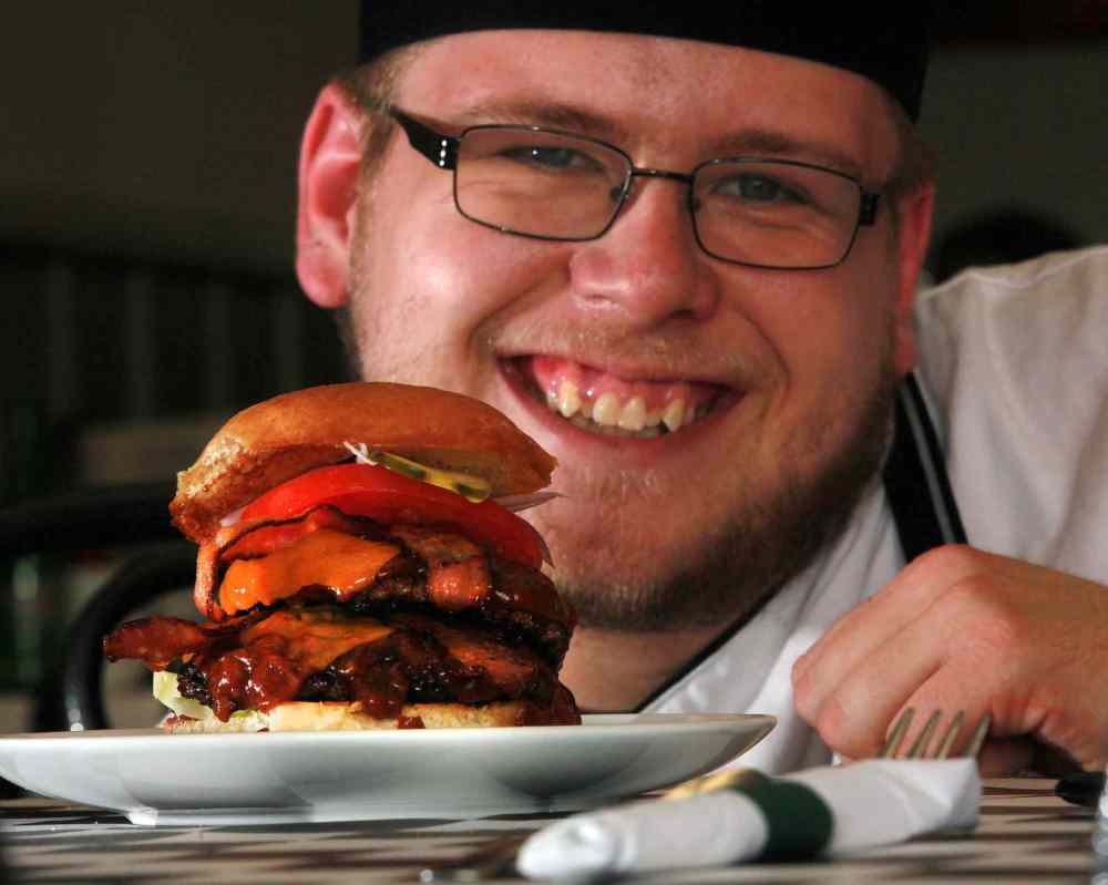 Phil Hossack / Winnipeg Free Press
DIner's Grill owner and chef Joshua Mesojednik serves up hearty eats, including his signature sandwich, the Double Diners cheeseburger.