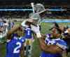 Winnipeg Blue Bombers' Matt Bucknor (2) and Jamaal Westerman (55) celebrate with the Banjo Bowl trophy after defeating the Saskatchewan Roughriders. (Trevor Hagan / Winnipeg Free Press)