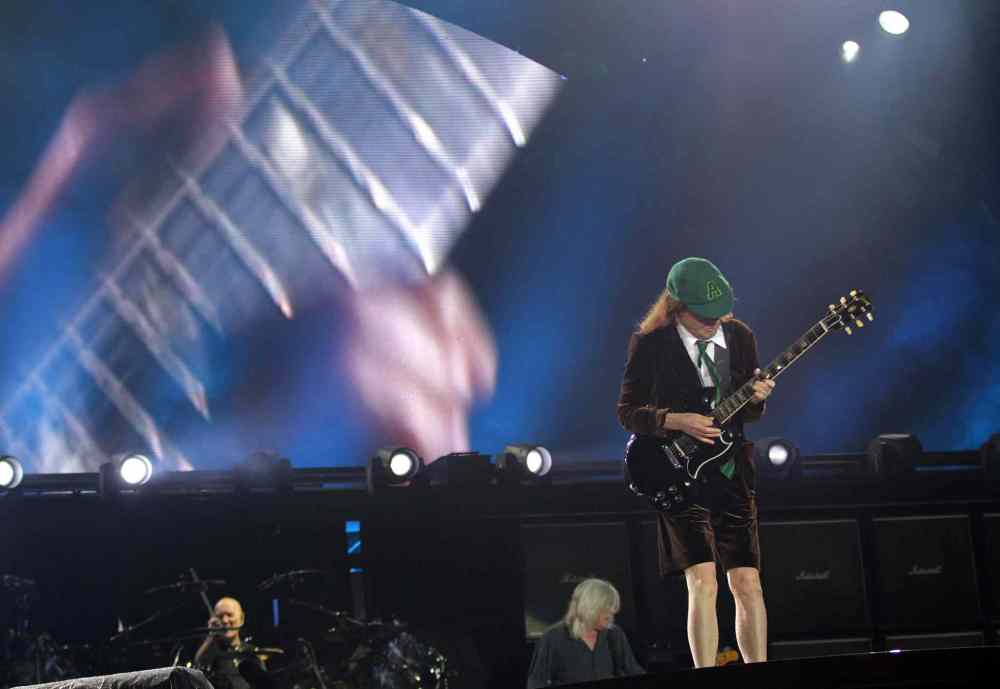 AC/DC's  Angus Young (right) at the Investor's Group Field in Winnipeg Thursday.  September 17, 2015 - (Phil Hossack / Winnipeg Free Press)
