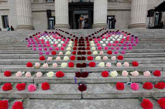 John Woods / Winnipeg Free PressA butterfly made of carnations sits on the steps of the Manitoba legislature as presenters speak at a gathering Sunday, part of the National Day of Action for Missing and Murdered Indigenous Women.