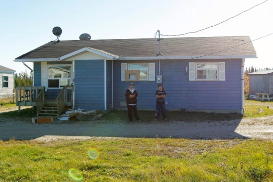 Two stepbrothers stand in the front of the home of Shelly Lynne Chartier on Tuesday. (Joe Bryksa/Winnipeg Free Press)