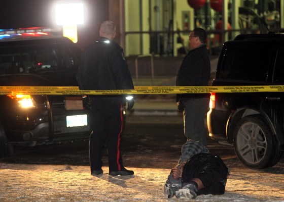Colin CorneauBrandon police secure a suspect at 19th Street and Louise Avenue, near Brandon University's Healthy Living Centre, Monday evening. (Colin Corneau/Brandon Sun)