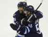 Trevor Hagan / Winnipeg Free Press
Winnipeg Jets' Blake Wheeler (26) and Mark Scheifele (55) celebrate after Scheifele scored a game winning goal in overtime against the Washington Capitals' in Winnipeg, Saturday, Dec. 5, 2015.
