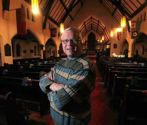 Phil Hossack / Winnipeg Free Press
All Saints Anglican Church priest  Brent Neumann poses in the historic sanctuary Tuesday evening.