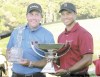 REUTERS
Phil Mickelson gives Tiger Woods a look as the world's No. 2 and No. 1 golfers hold their respective trophies. Both came out big winners Sunday at East Lake.